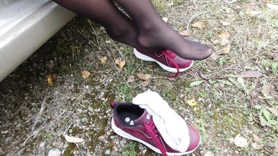 Sexy girl in stockings shows her legs and wears dress white socks feet foot fetish