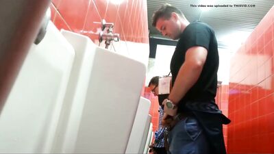 small dicked guy taking a peek a bigger dick at urinal - free gay porn