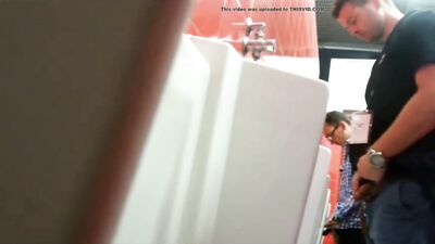 small dicked guy taking a peek a bigger dick at urinal - free gay porn